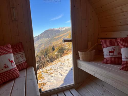 a room with a window with a view of a mountain at Sonnalm Panoramablick Garten Sauna in Rohrberg