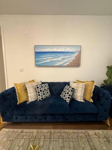 a blue couch with pillows on it in a living room at Luxury Spacious 2 bd apt pool gym Americana in Glendale