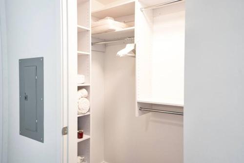a white closet with a door and a window at Luxury Spacious 2 bd apt pool gym Americana in Glendale