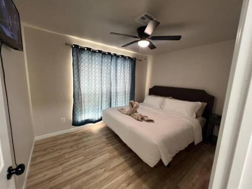 a bedroom with a bed with a teddy bear on it at Comfort Home WiFi n Hottub in Midwest City