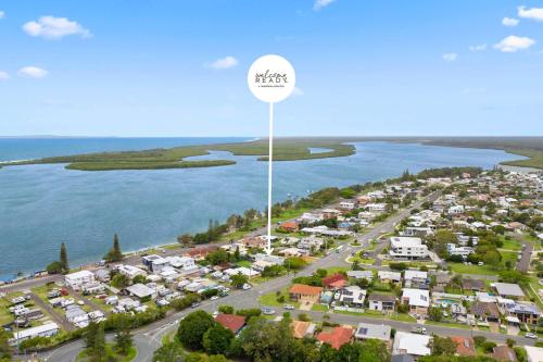 an aerial view of a suburb next to the water at Pumicestone Beach House - 200m to the passage in Pelican Waters