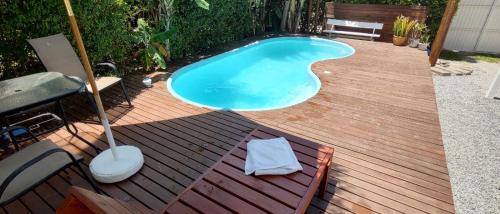 a small swimming pool on a wooden deck at Cabana ferrugem pool in Garopaba