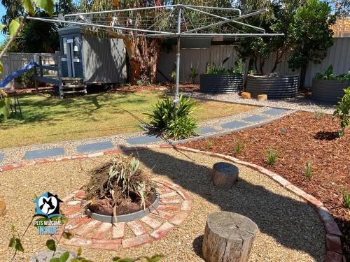 a backyard with a garden with a fire pit at Saltwater Sunsets Seaside Haven with Ocean Views in Victor Harbor
