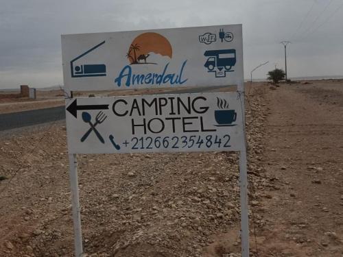 a sign for an emergency camping hotel on the side of a road at Amerdoul in Icht