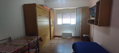 a small room with two beds and a window at Monoambiente MDQ in Mar del Plata