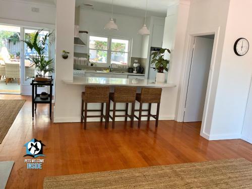 a kitchen with a table and chairs in a room at Saltwater Sunsets Seaside Haven with Ocean Views in Victor Harbor