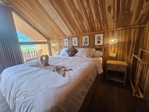 a person laying on a bed in a room at Dynasty Glamping Bedugul in Bedugul