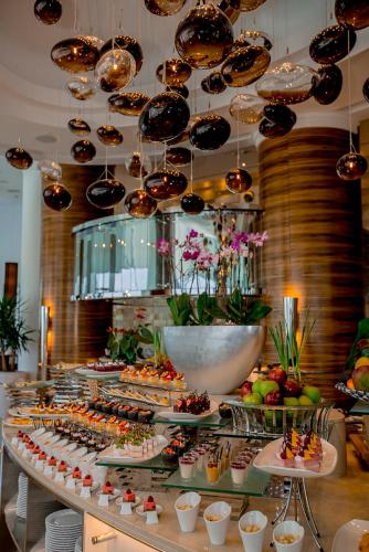 a buffet with appetizers and desserts on a table at Grand Millennium Sulaimani in As Sulaymānīyah