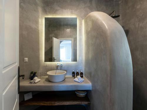 a bathroom with a sink and a mirror at Impressive villa with views in Psarou