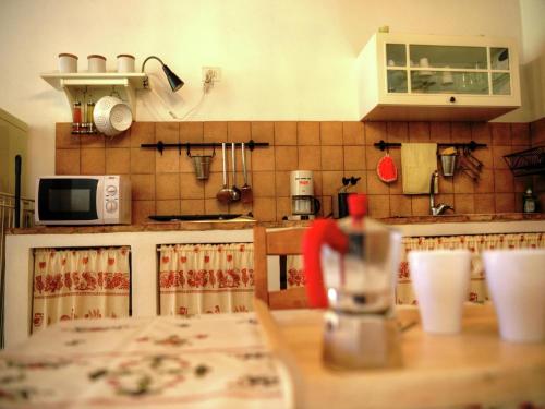 a kitchen with a wooden table with a counter top at Scenic holiday home in Modigliana with fenced garden in Modigliana