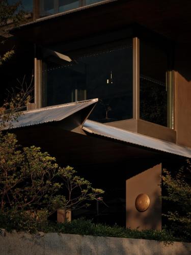 a view of a building with a window and a ball in a box at Yakamoz Qianchuan Hotel in Lin'an