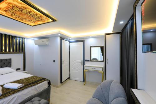 a bedroom with a bed and a desk with a mirror at Istanbul Hotel&Guesthouse in Istanbul