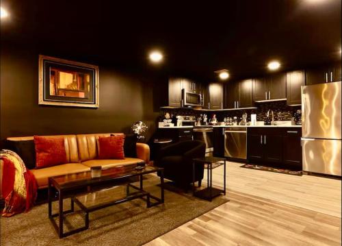 a living room with a couch and a kitchen at Bloomingdale Blues Speakeasy Free Parking in Washington, D.C.