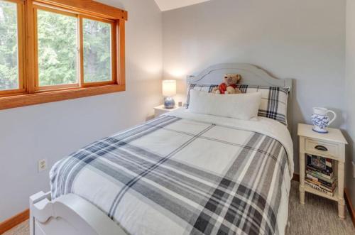 a teddy bear sitting on a bed in a bedroom at Waterville Wonderland in Thornton
