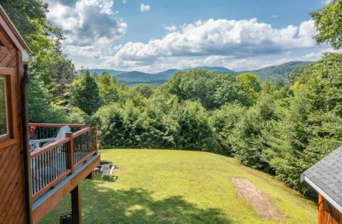 a view from the deck of a home with a view of the mountains at Waterville Wonderland in Thornton