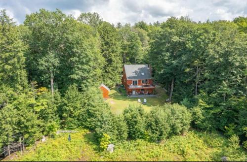 an aerial view of a house in the woods at Waterville Wonderland in Thornton