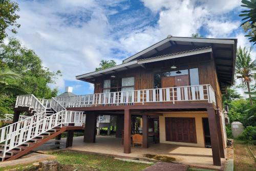 a house with a staircase leading up to it at Karaboon Wellness in Phitsanulok