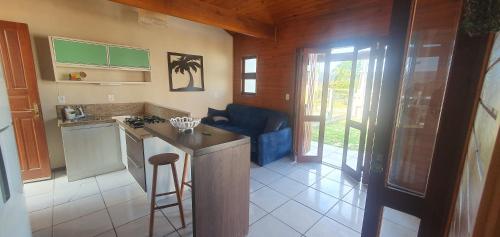 a kitchen with a stove and a counter top at Linda casa com piscina 50m praia in Arroio do Sal