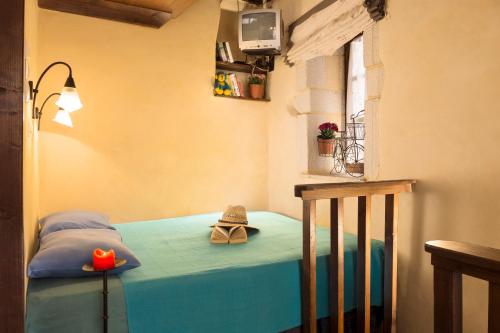 a bedroom with a bed with a hat on it at Old Stone House in Chania Town
