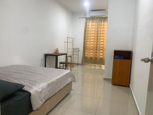 a bedroom with a bed and a table and a window at d'Tempat Country Club, Hijayu 3d, Terrace House in Siliau