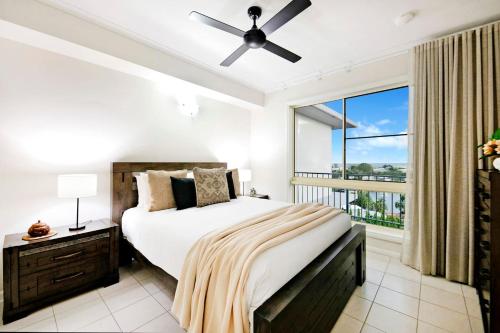 a bedroom with a bed and a large window at Sunset Penthouse - Unique Panoramic Rooftop Retreat in Larrakeyah