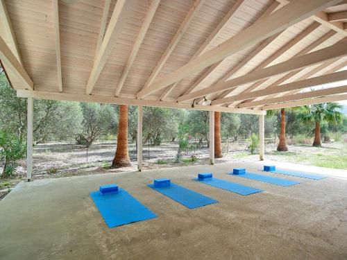 a group of blue yoga mats in a pavilion at Mousses Apartments & Studios in Kissamos