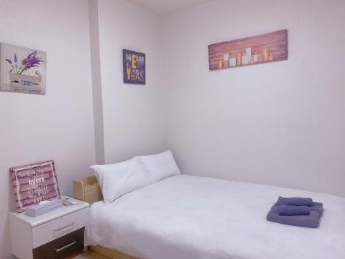 Ένα ή περισσότερα κρεβάτια σε δωμάτιο στο yikebukuro LuckyHouse 池袋一軒家 幸運の家