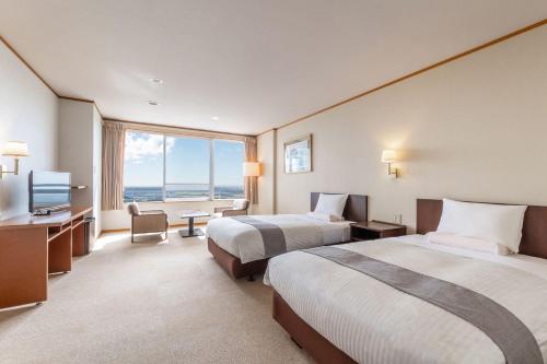 Ένα ή περισσότερα κρεβάτια σε δωμάτιο στο Kamenoi Hotel Tsukubasan