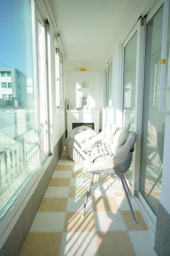 a room with two chairs on a balcony with windows at Gyeongju Florian Stay Stay Close Explore More in Gyeongju