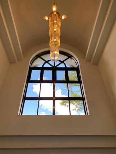 a chandelier hanging from a ceiling with a window at Sansui Resorts Yamanakako in Yamanakako