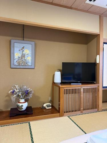 a living room with a flat screen tv on a shelf at Sansui Resorts Yamanakako in Yamanakako