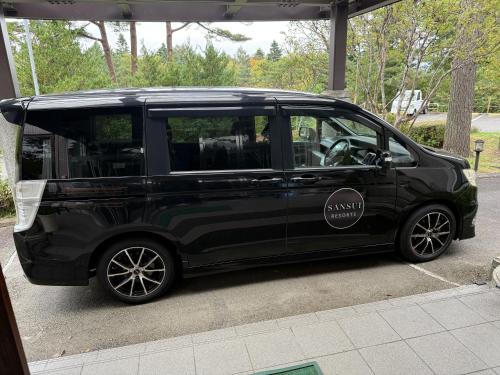a black car parked in a parking lot at Sansui Resorts Yamanakako in Yamanakako