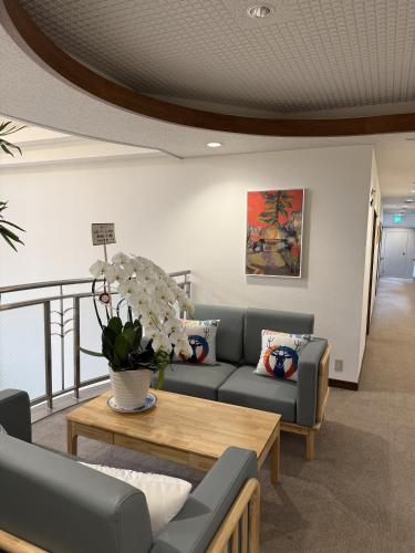 a living room with a couch and a table at Sansui Resorts Yamanakako in Yamanakako