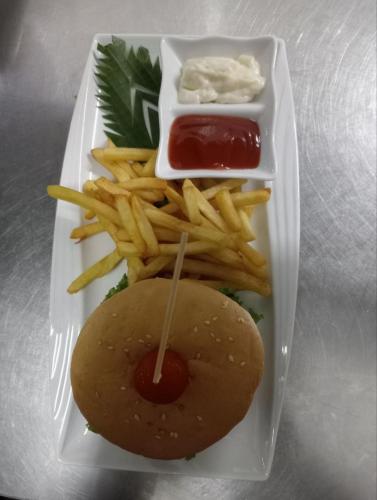 a tray with a sandwich and french fries and ketchup at David Hostel in Koh Rong