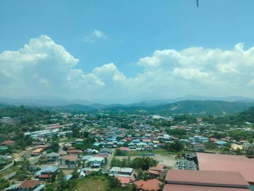 an aerial view of a city with mountains in the background at ITCC Manhattan Suites by Kansayan Homestay in Penampang