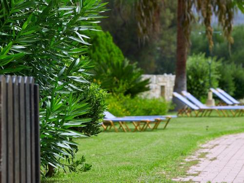 a row of lounge chairs in a park at Mousses Apartments & Studios in Kissamos