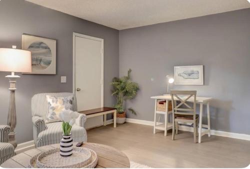 a living room with a table and a chair at #88 Elegant 3-Bedroom Pet Friendly with Parking in Hilton Head Island