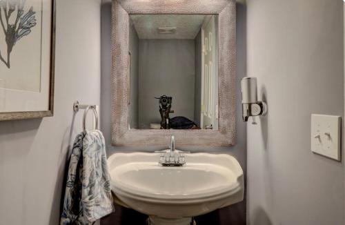 a bathroom with a white sink and a mirror at #88 Elegant 3-Bedroom Pet Friendly with Parking in Hilton Head Island