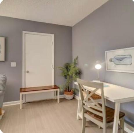 a living room with a table and a chair at #88 Elegant 3-Bedroom Pet Friendly with Parking in Hilton Head Island