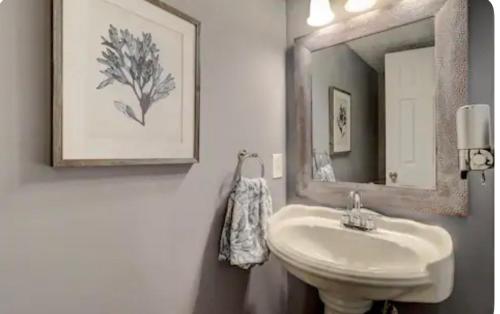a bathroom with a sink and a mirror at #88 Elegant 3-Bedroom Pet Friendly with Parking in Hilton Head Island