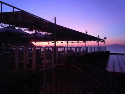 a building with a sunset in the background at Suite Hotel Nettuno in Sestri Levante