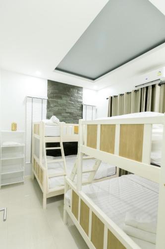 a room with several bunk beds in it at บลูสกาย พูลวิลล่า ชะอำ หัวหิน Blue Sky Pool Villa in Ban Bo Fai (1)