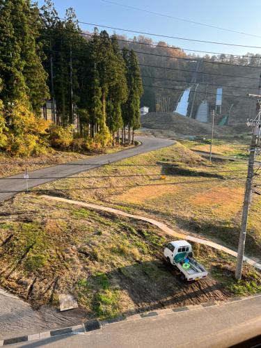 a white van parked on the side of a road at Nozawa-SF Pre Renovation in Nozawa Onsen