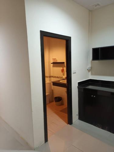 a room with a bathroom with a toilet and a sink at New Lavender Hotel Patong in Patong Beach