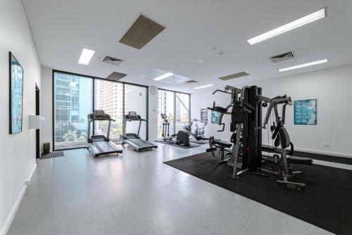 a gym with treadmills and ellipticals in a building at Lux 39th floor 3br 2bath, River view, Pool, Gym, Wifi in Brisbane