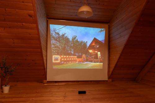a large window in a room with a picture of a house at SUGI BASE Biwako in Otsu