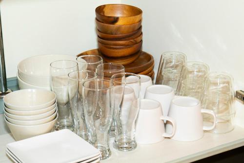 a bunch of glasses and plates on a table at SUGI BASE Biwako in Otsu