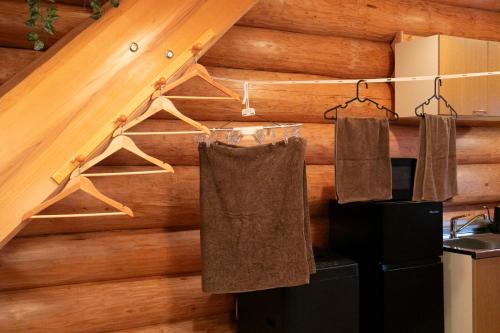 a kitchen with towels hanging from a wooden wall at SUGI BASE Biwako in Otsu