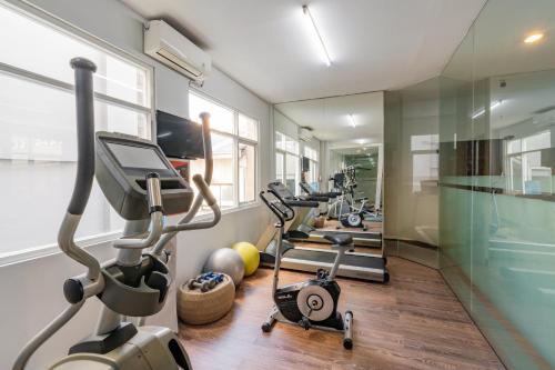 a row of treadmills and exercise bikes in a gym at b Hotel Bali & Spa in Denpasar