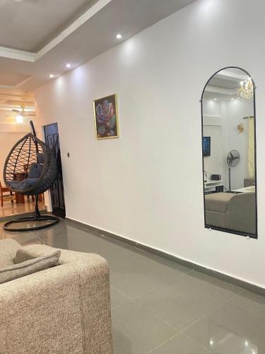 a living room with a mirror and a couch at deux chambres et salon chez 198 à Porto Novo in Porto-Novo